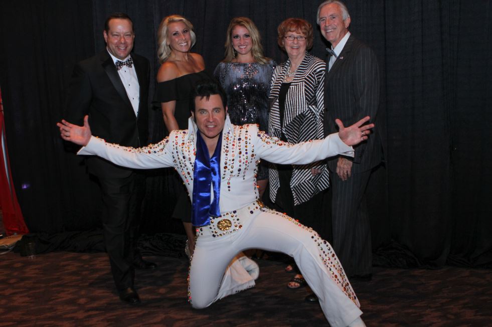 Saint Luke's East, CEO Ron Baker with guests, and Elvis, at annual Boo Ball event