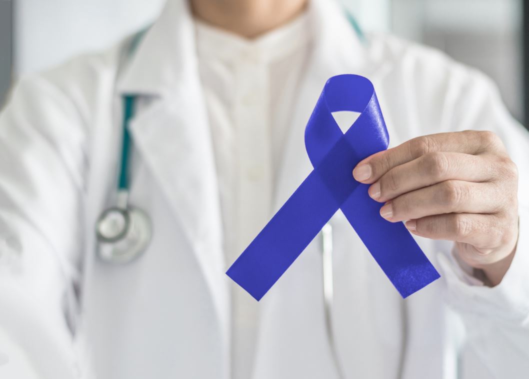 Doctor holding blue ribbon