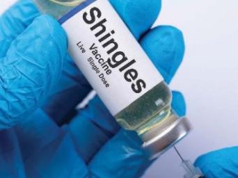 Person holding vile of Shingles Vaccine - live single dose.