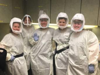 Nurses standing together wearing PPE 