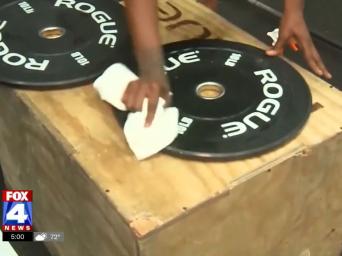 FOX4 News. Hand cleaning off weights with a rag