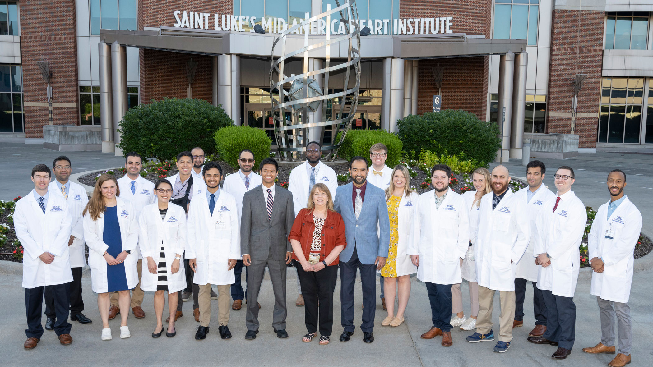 A group of cardiologists and program leaders stands outside the Saint Luke's Mid America Heart Institute.