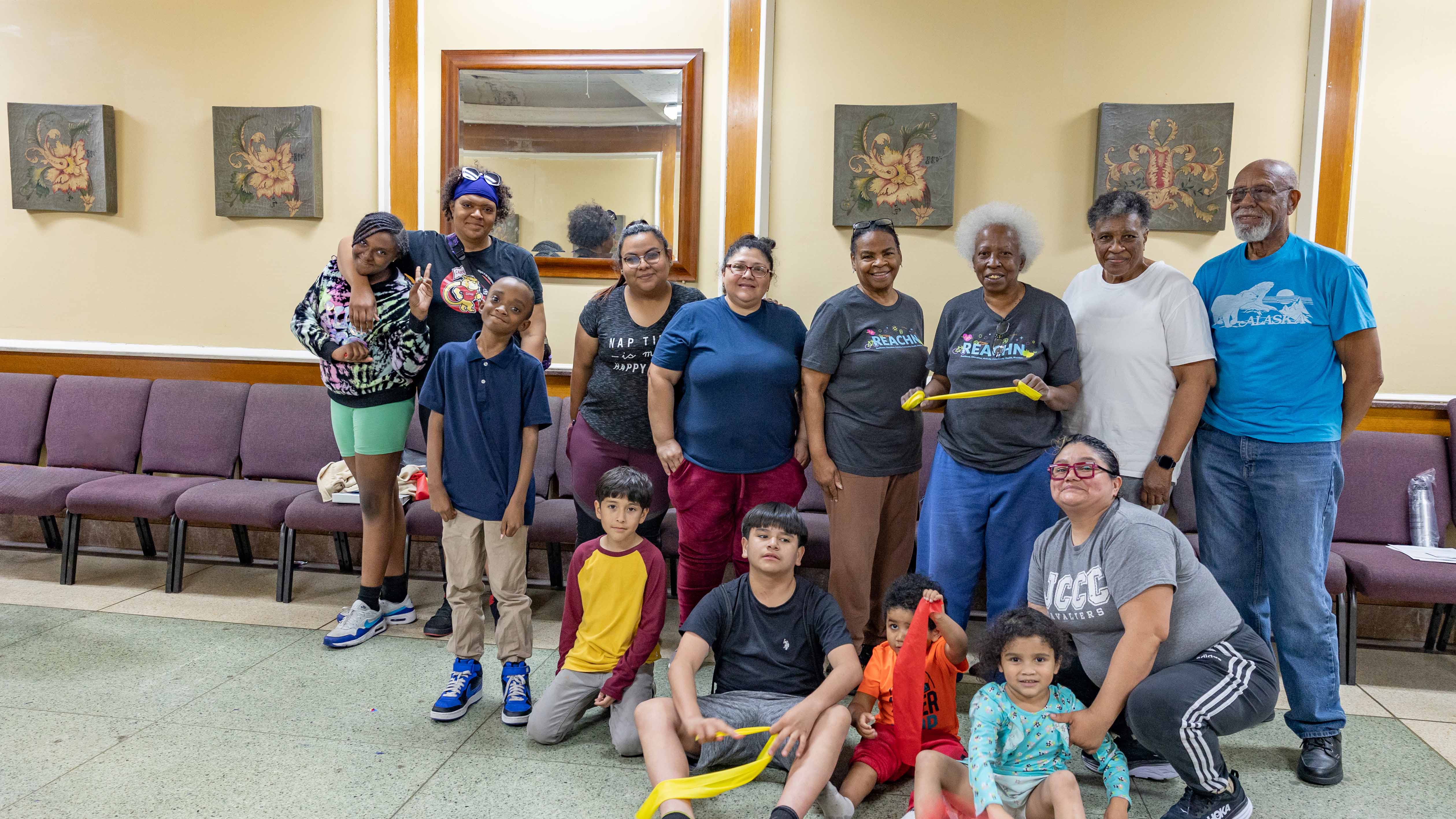 A group of smiling workers in the REACHN program.