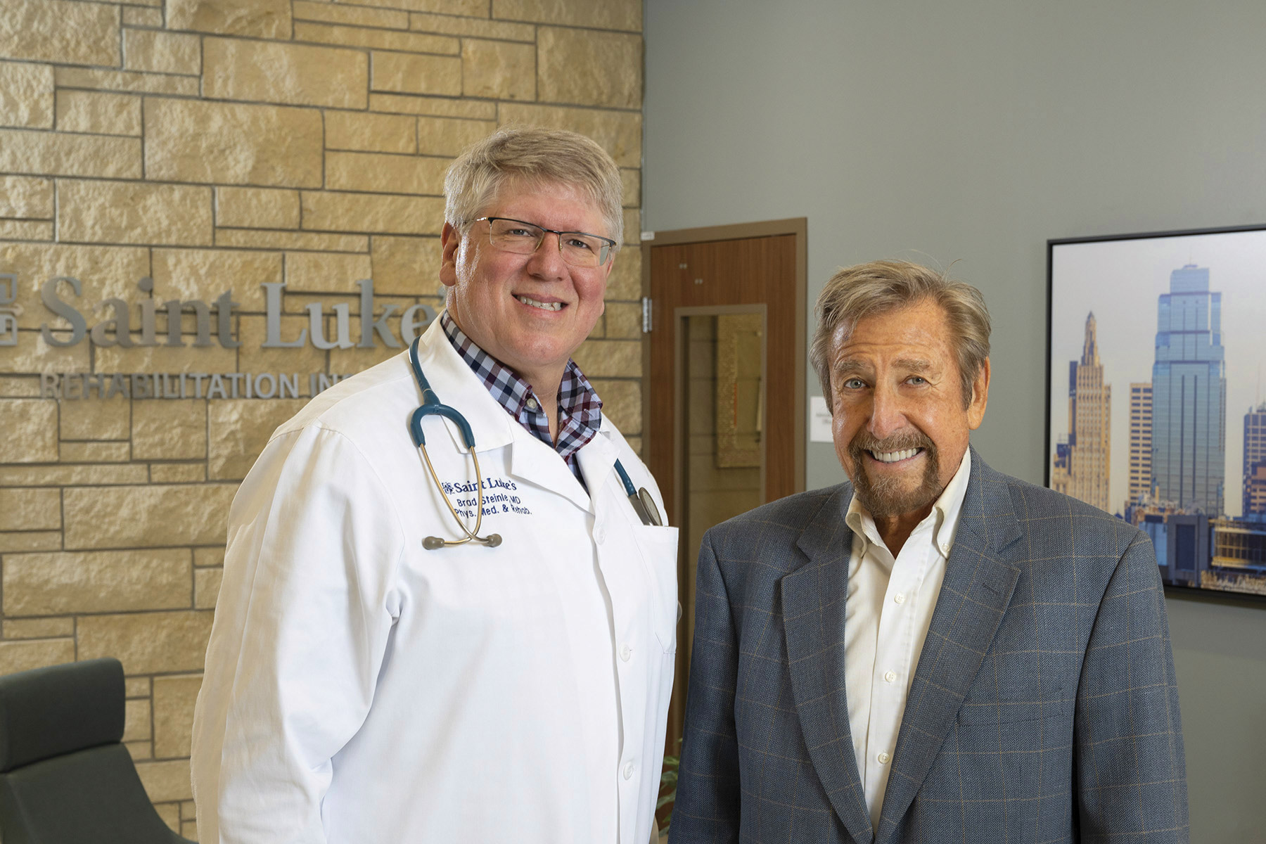 A doctor standing next to a happy patient
