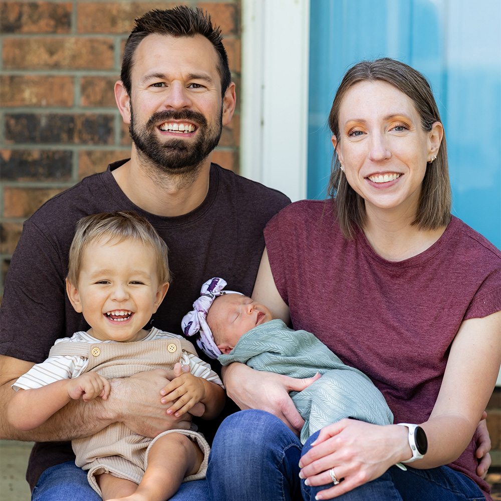 Larson family portrait including, Aria, her husband, and their two children, Silas and Rowan, both who received SMA treatment.