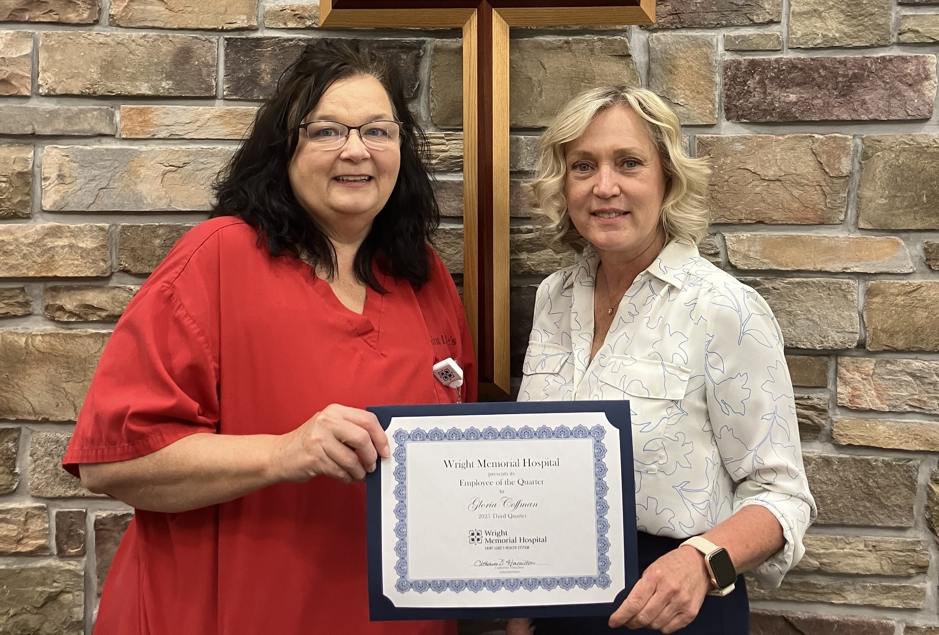 Gloria Coffman receiving award from Catherine Hamilton. 