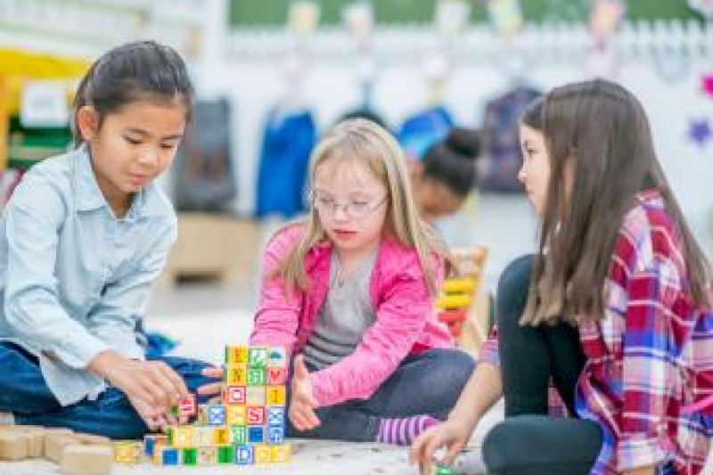 A group of children, playing at school with blocks