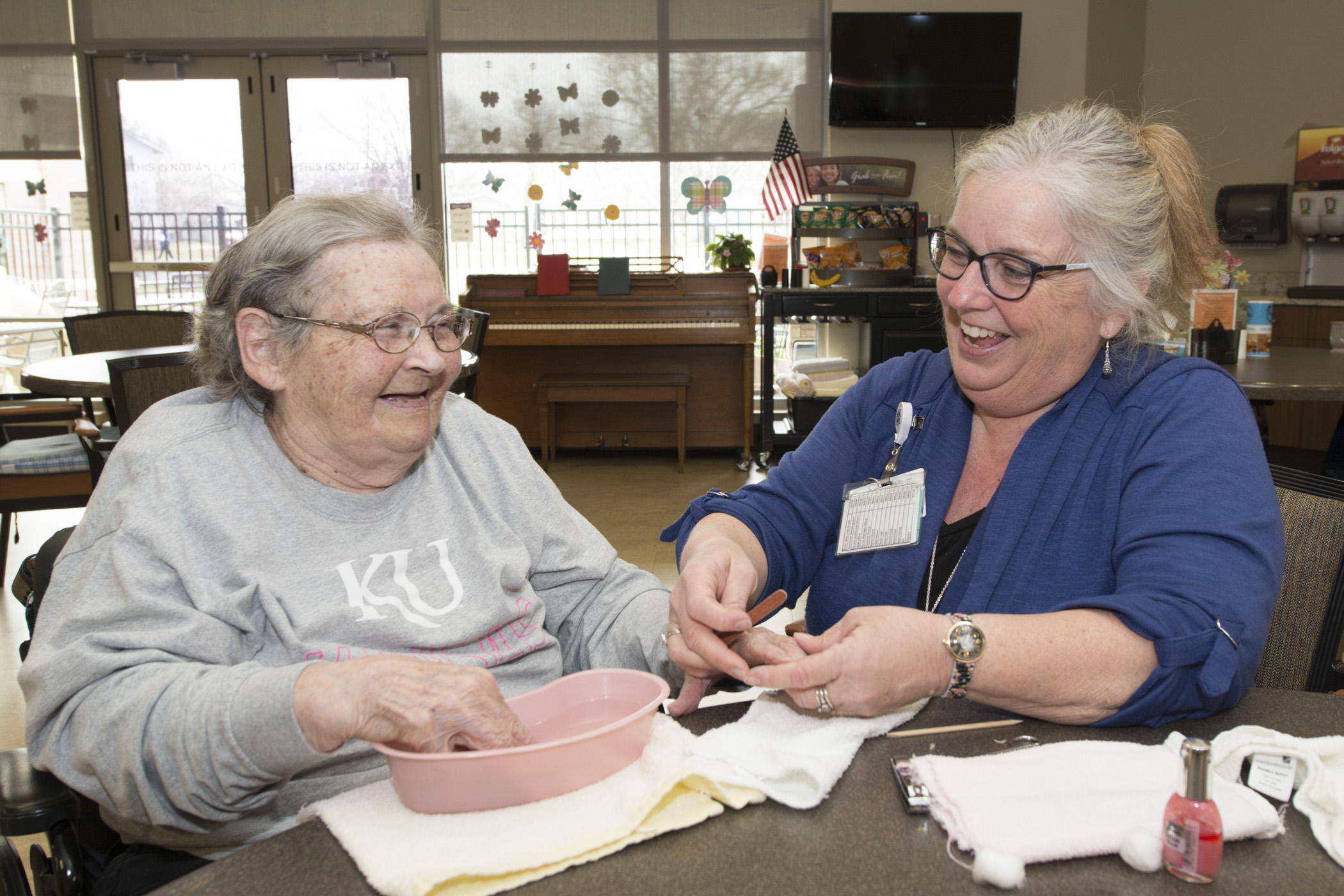 A provider laughs with a patient at the Residential Living Center, named one of the best nursing homes in Kansas by U.S. News & World Report