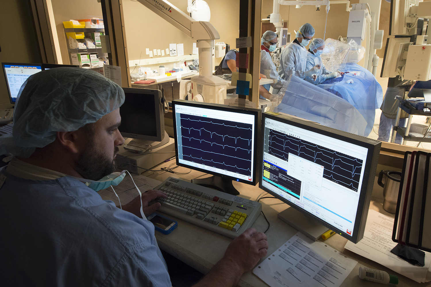 A electrophysiology laboratory employee monitors