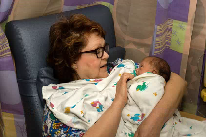 Carol Hayward, 72, of Kansas City, Kan., cuddling a baby at Saint Luke’s Hospital of Kansas City