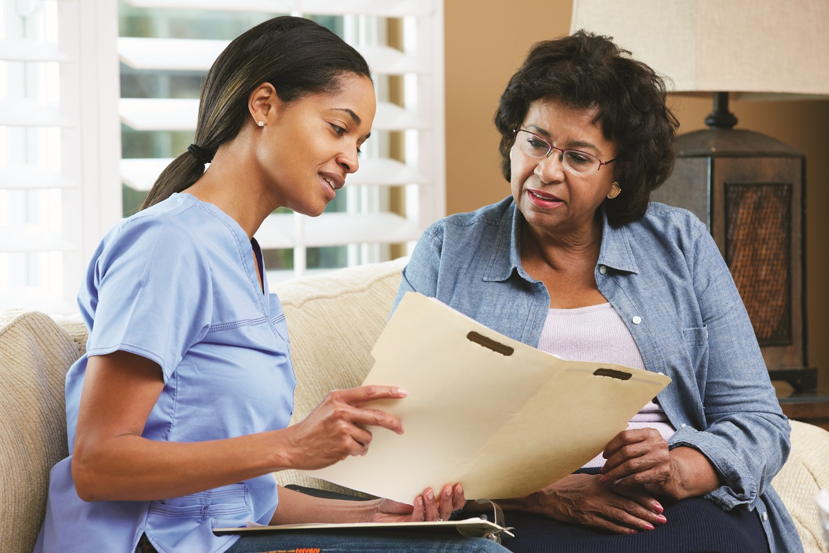 A caregiver talks to a patient about the Saint Luke's palliative care services