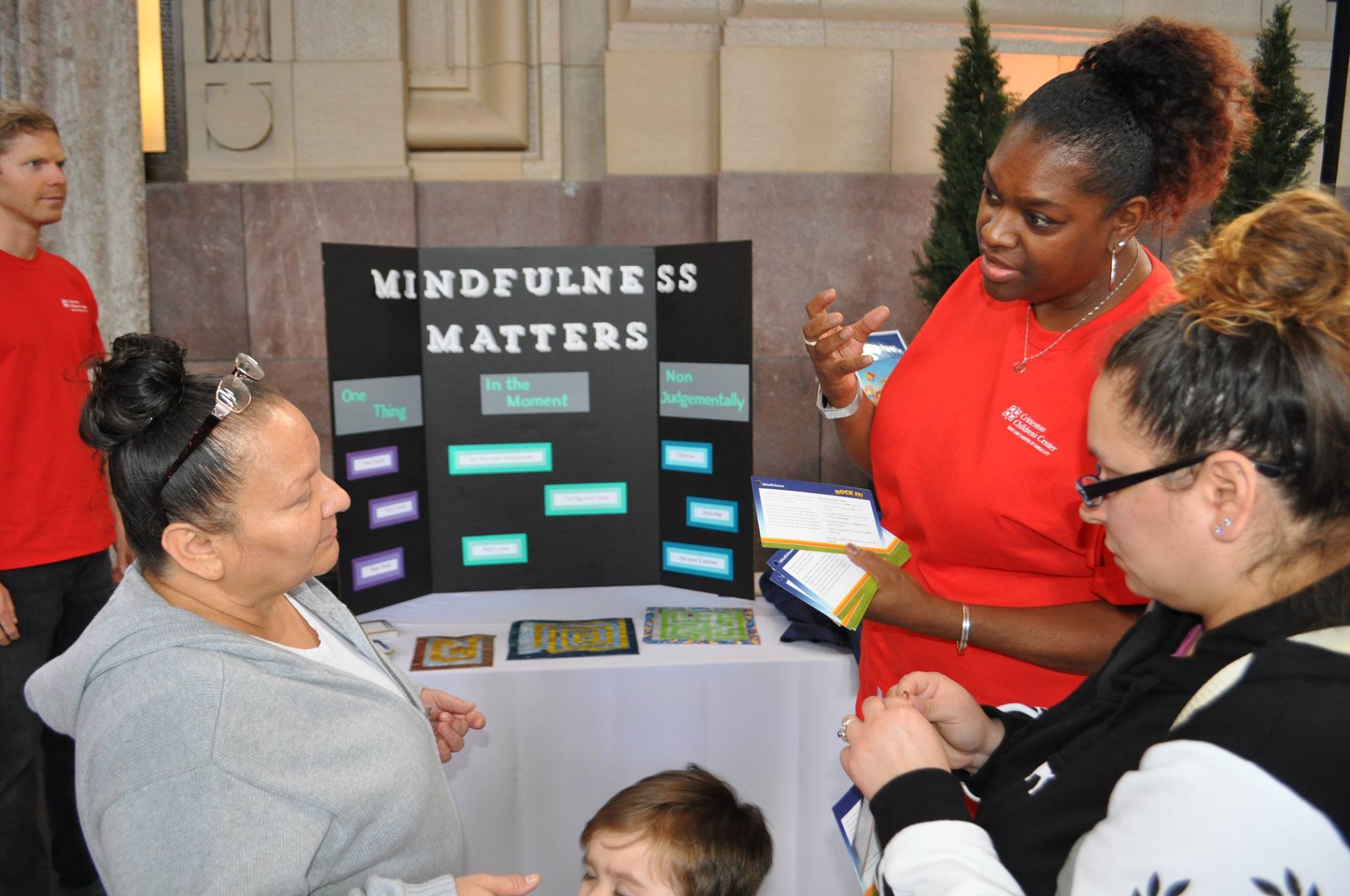 Experts talking with a family at the booth "Mindfulness Matters" at Rock It