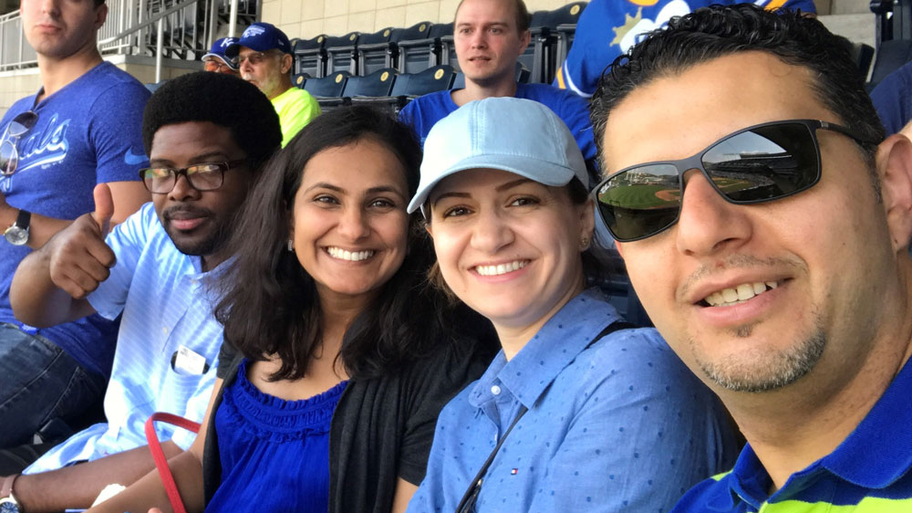 Fellows Poghni Peri-Okonny, MD; Krishna Patel, MD, MS; and Firas Al-Badrin, MD attend a baseball game.
