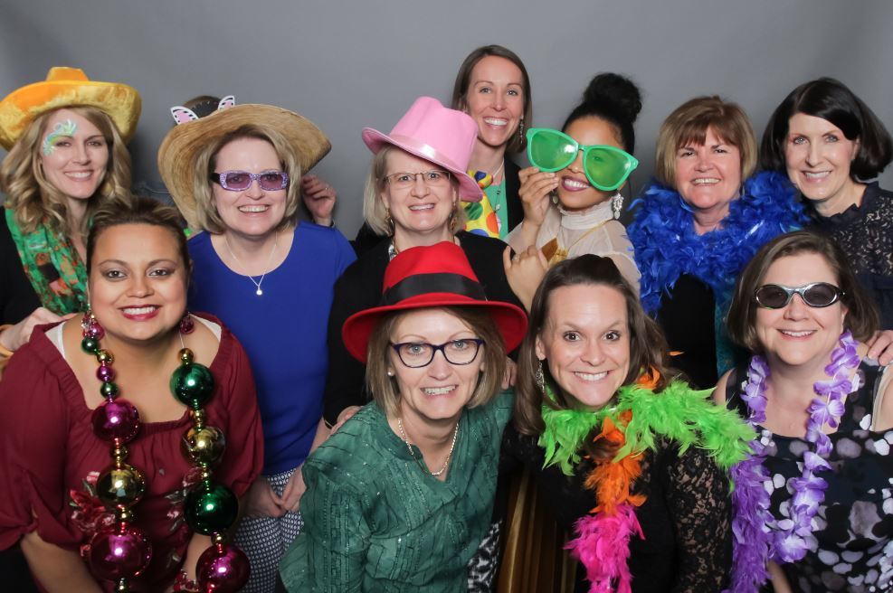 Staff from the Children's SPOT gather for a fun photo dressed in photo props
