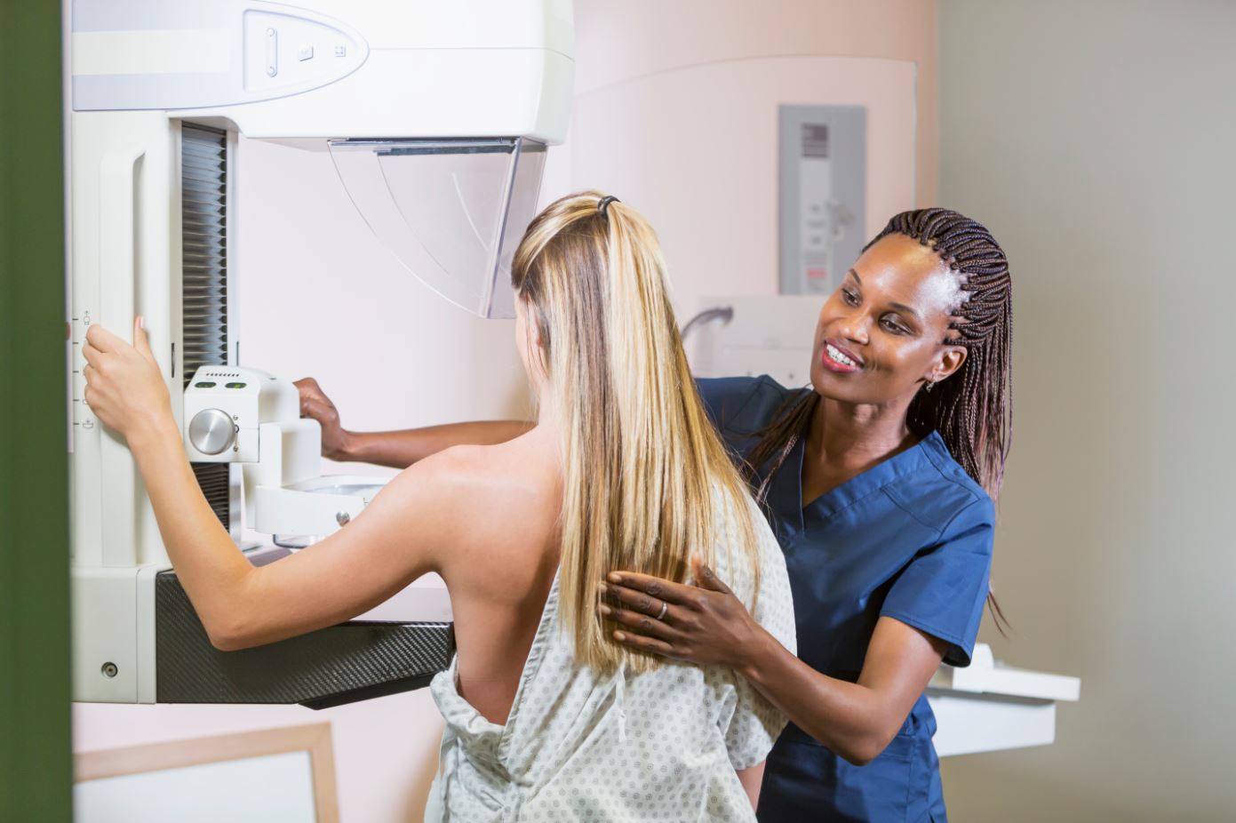 nurse helping patient with her 3D mammogram