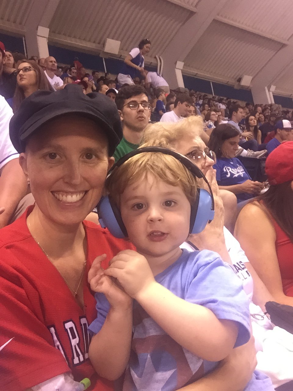 Laurel Grable and her son in the stands at a baseball game