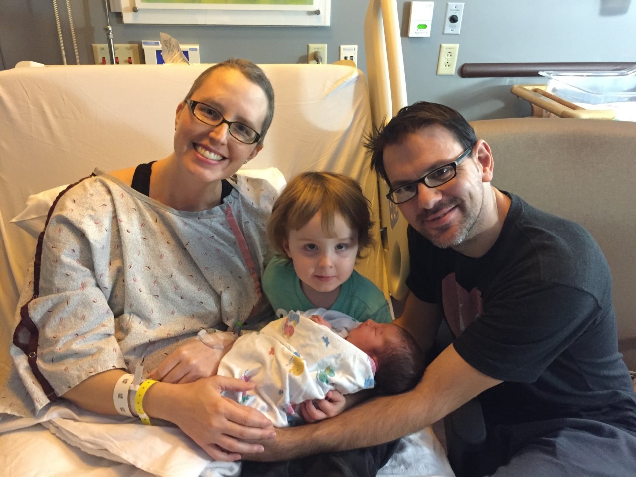 Laura Grable, her husband, and son holding newborn baby