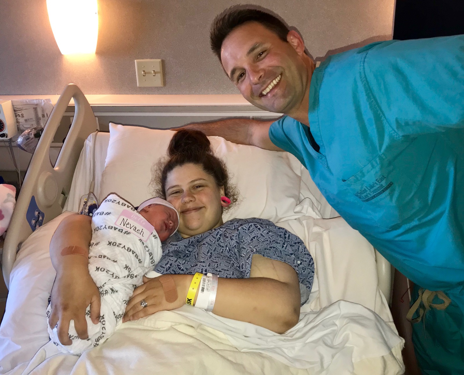 Neveah (Saint Luke's East Hospital's 20,000th baby), Tricia (mom) and Dr. Rocco Florio gather together.