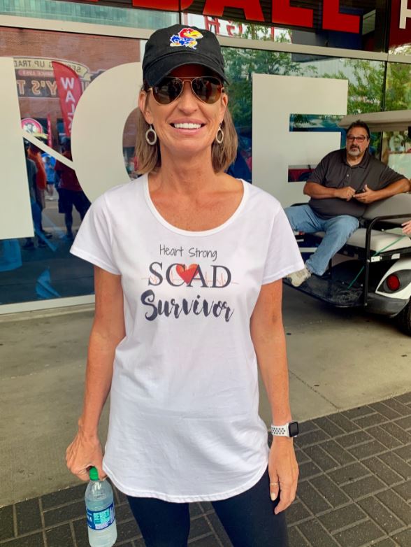 Dana Garrison at the AHA heart walk wearing a heart strong SCAD survivor t-shirt.