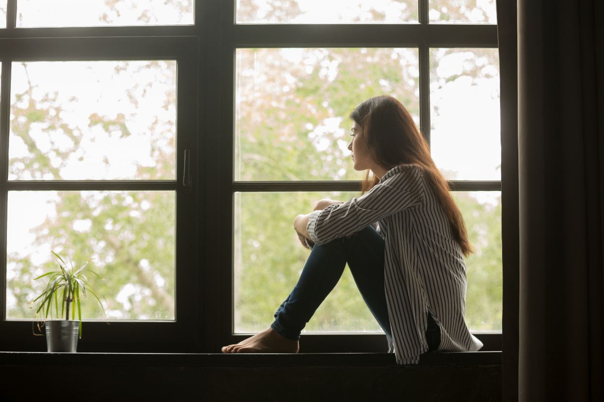 Woman looking out of a window.