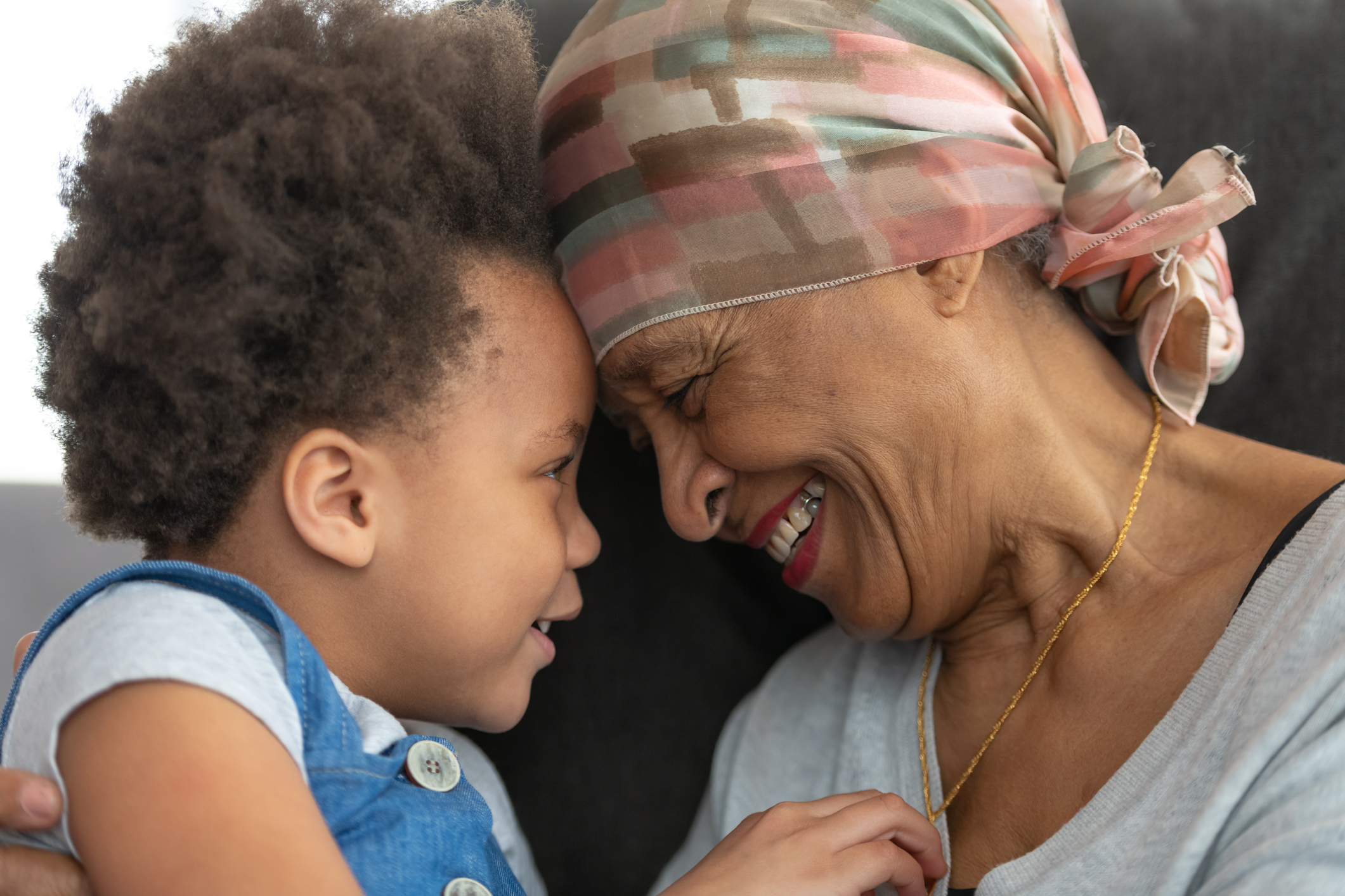 Senior woman smiling, holding child