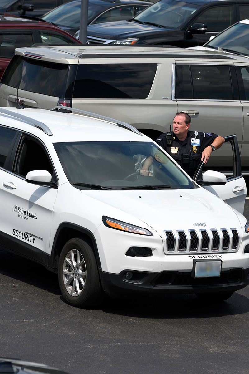 Sgt. Anthony Cook standing by the security vehicle