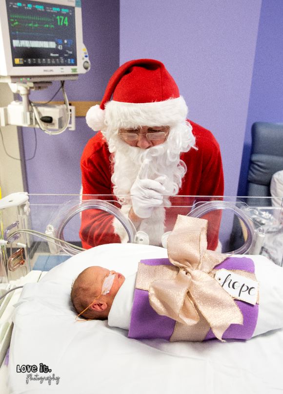 Santa next to baby in the NICU