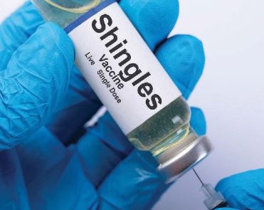 Person holding vile of Shingles Vaccine - live single dose.