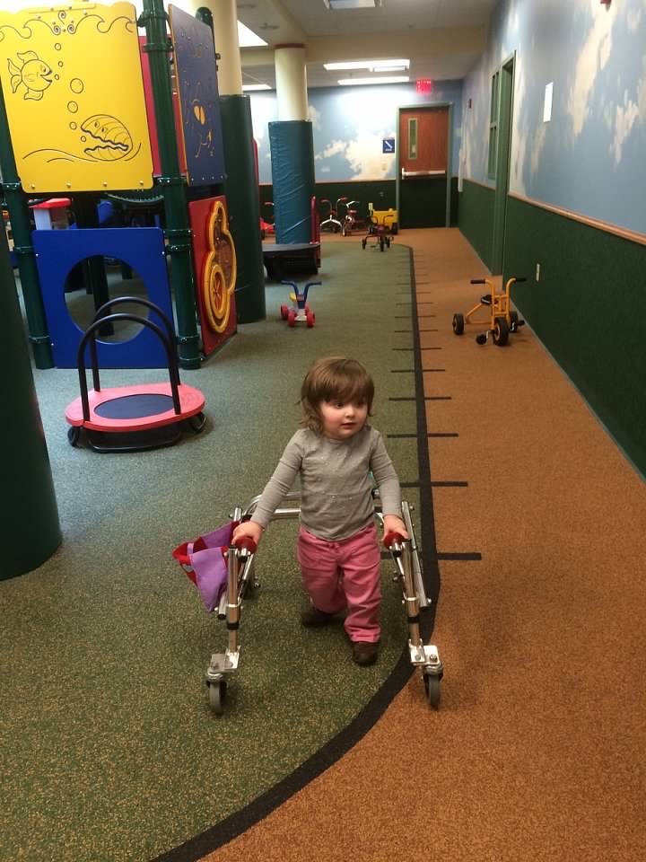 In March 2015, Amelia got her reverse walker. She loved using it at the SPOT (pictured here) or anywhere with wide open spaces. She would zoom through Target and her mom, Jennifer, prayed she wouldn’t knock anyone down!