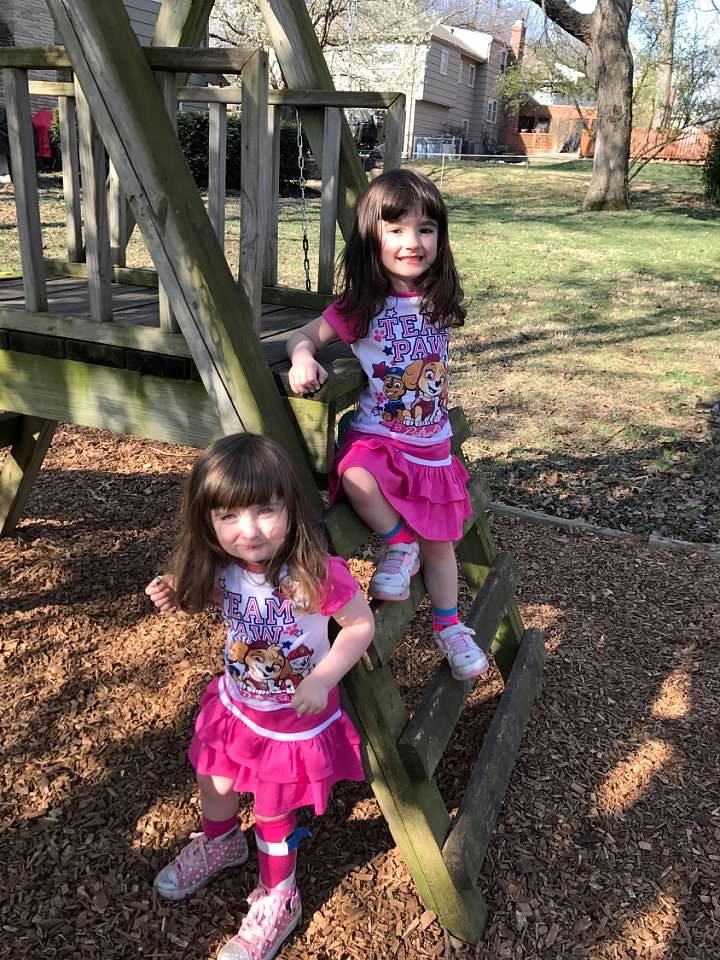 Amelia, pictured with her twin sister, Sarah, practiced walking on uneven surfaces (like grass or wood chips) and climbing play equipment in their backyard in the spring 2017.