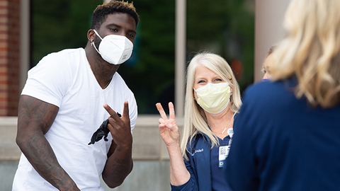 Tyreek Hill posing for a photo with a Saint Luke's nurse