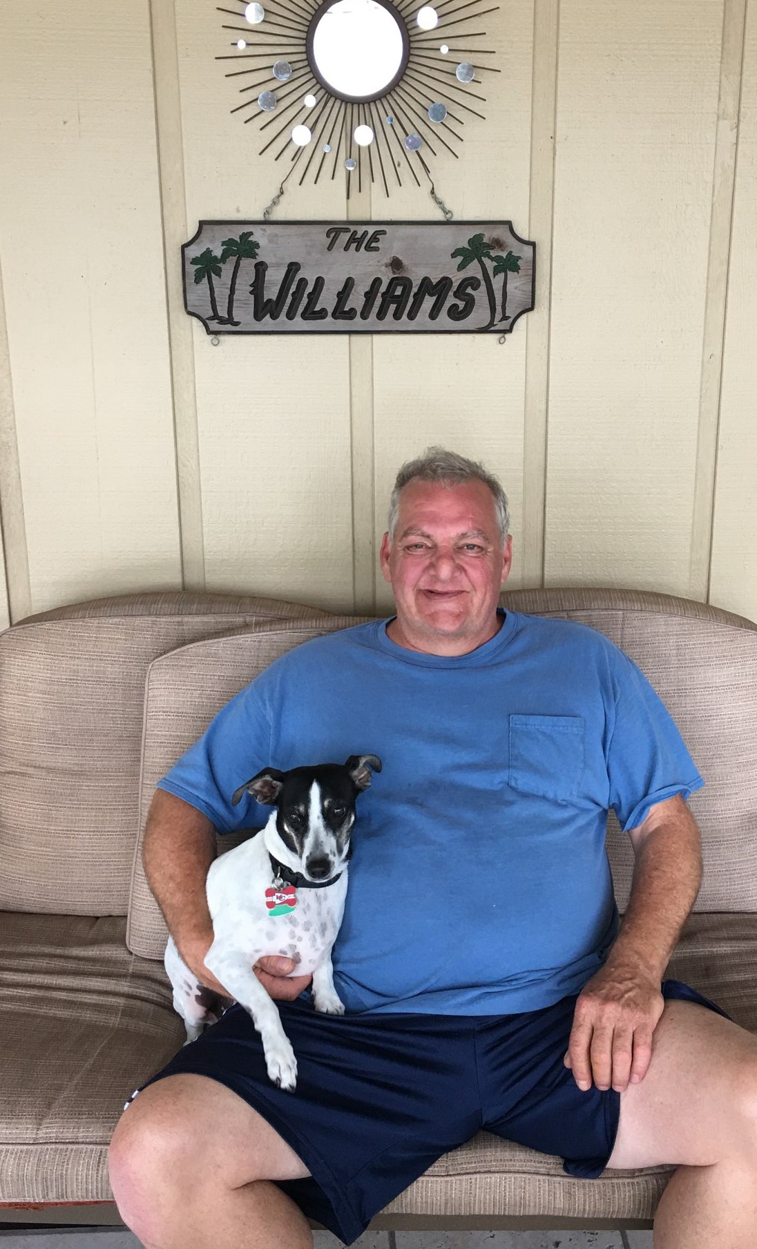 Birch and his dog sitting outside on their front porch. 