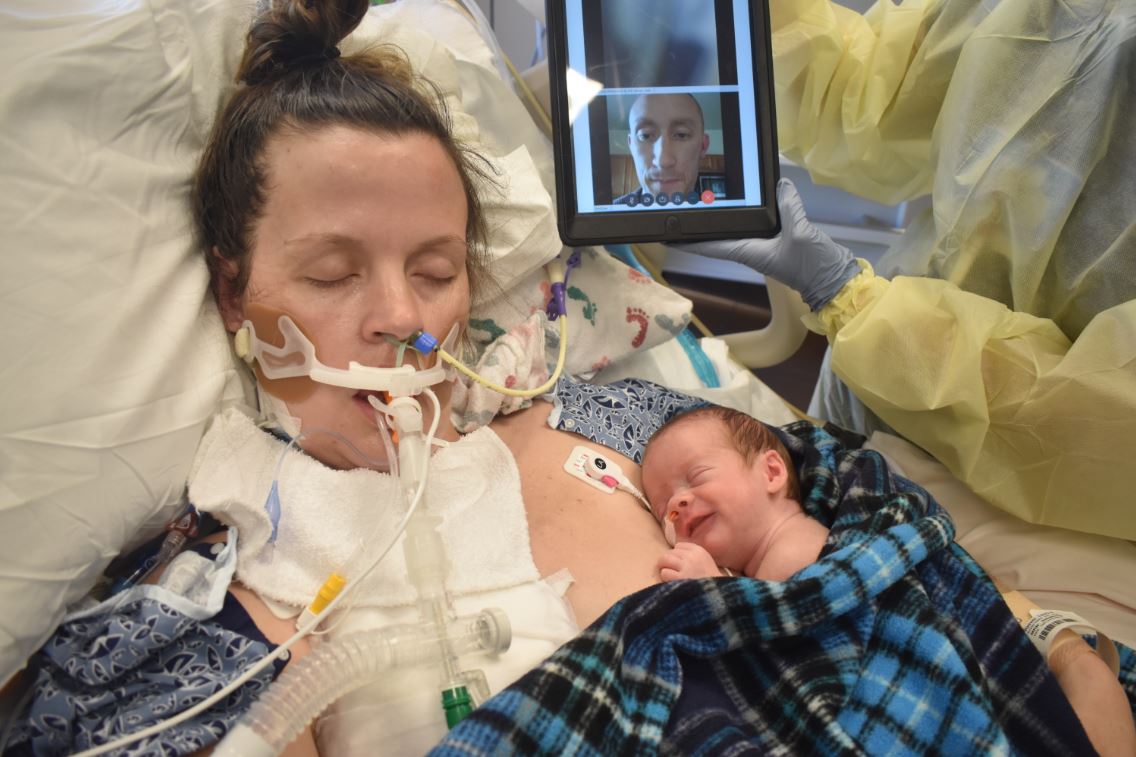 Laura Steeves hooked up to a ventilator, holding her newborn baby as nurse FaceTimes her husband