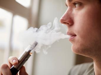 Teen vaping an e-cigarette