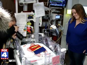 FOX4 News:baby is dressed up at Saint Luke's NICU as wonder woman and gets her photo taken for her first Halloween as mom watches
