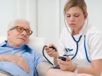 doctor taking patients blood pressure