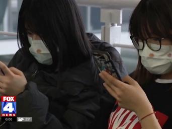 FOX 4 News. Two women wearing surgical face masks