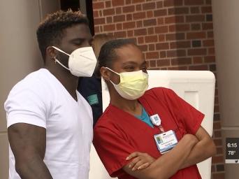 KCTV 5 News. Tyreek Hill posing with a Saint Luke's Hospital employee