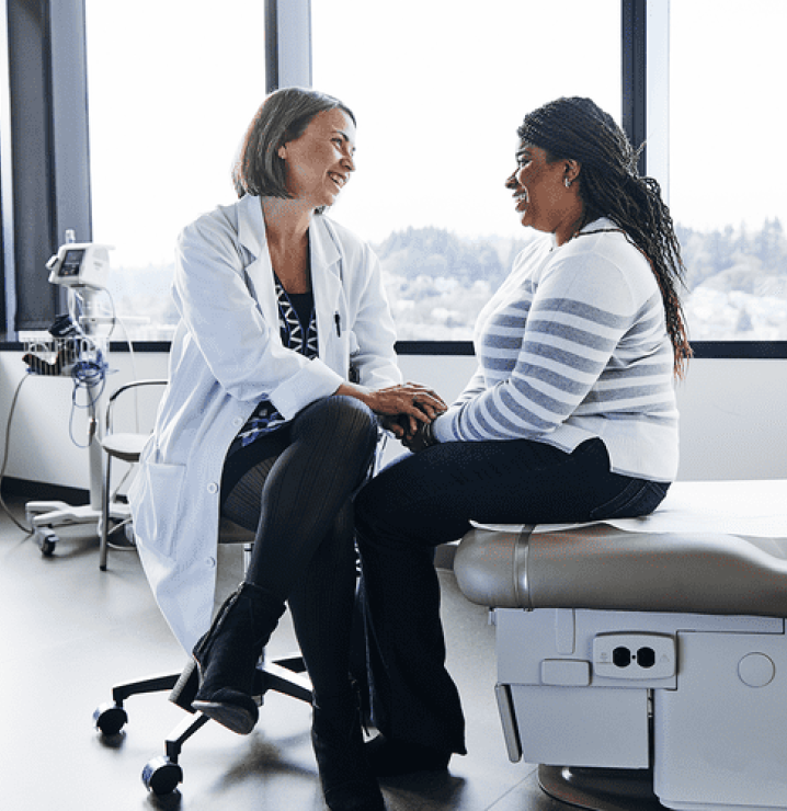 Female doctor speaking to female patient