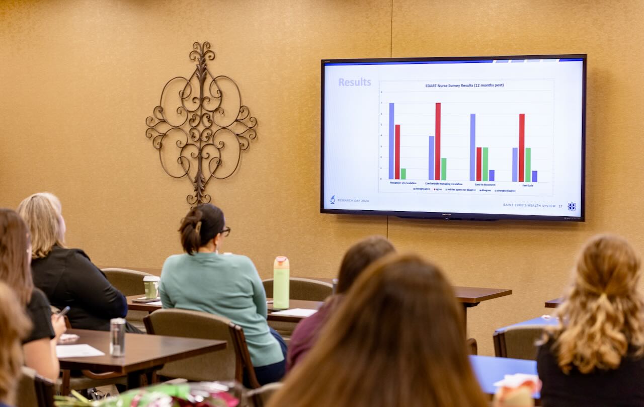 Researchers in a conference room looking at a presentation