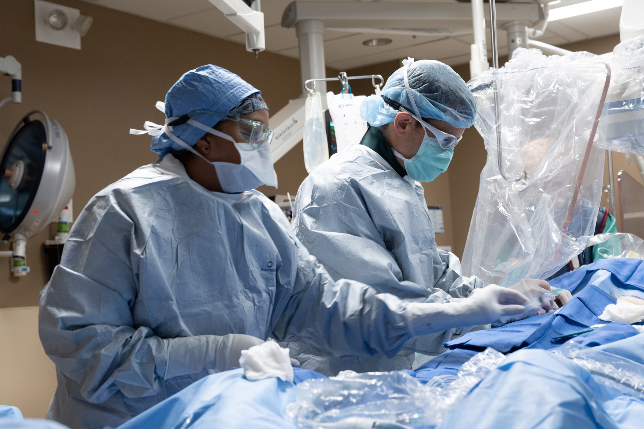 Saint Luke's electrophysiology cardiologists are working in a patient in an operating room.