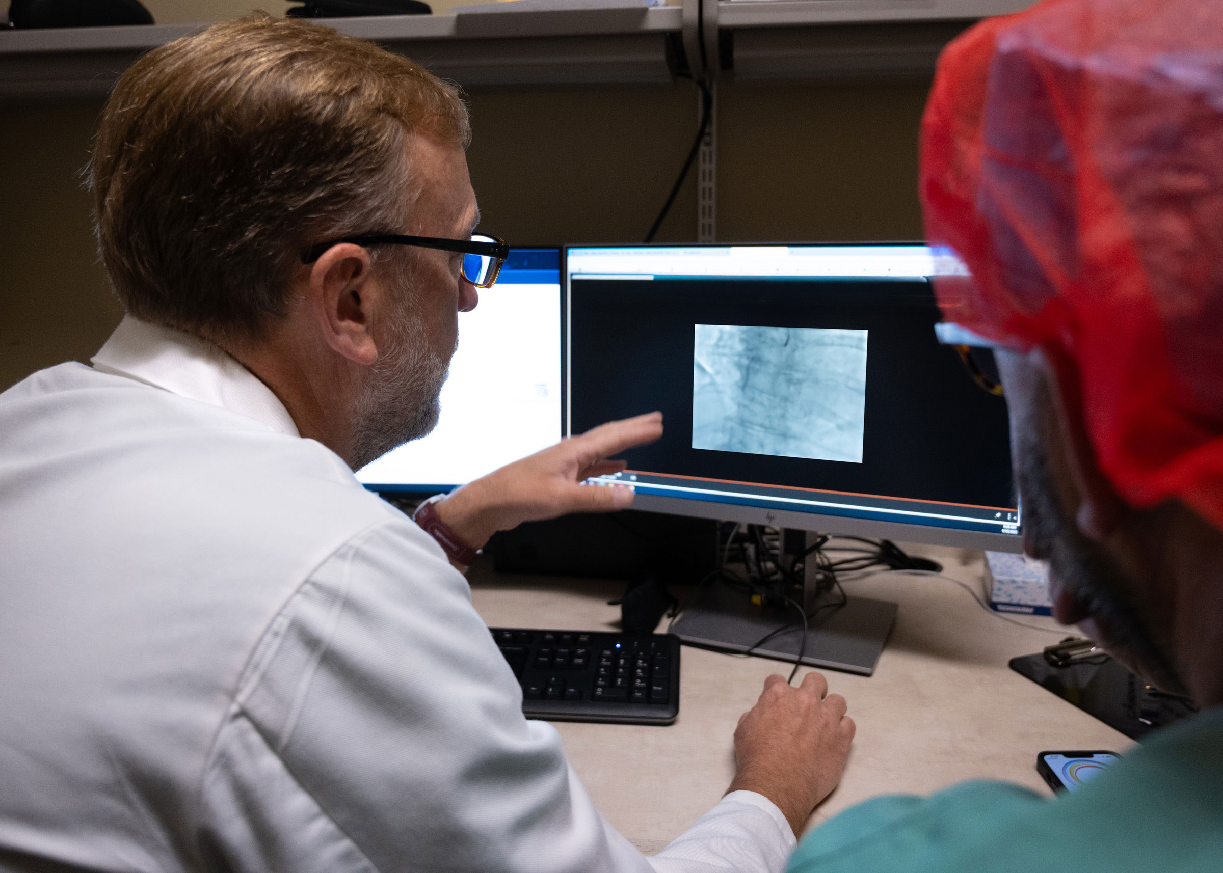 A Saint Luke's cardiologist reviews a scan displayed on a computer monitor.