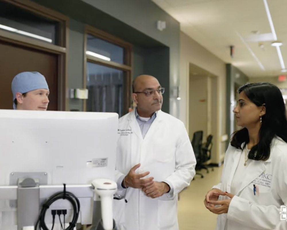 Saint Luke's cardiovascular program directors and fellows stand around a monitor