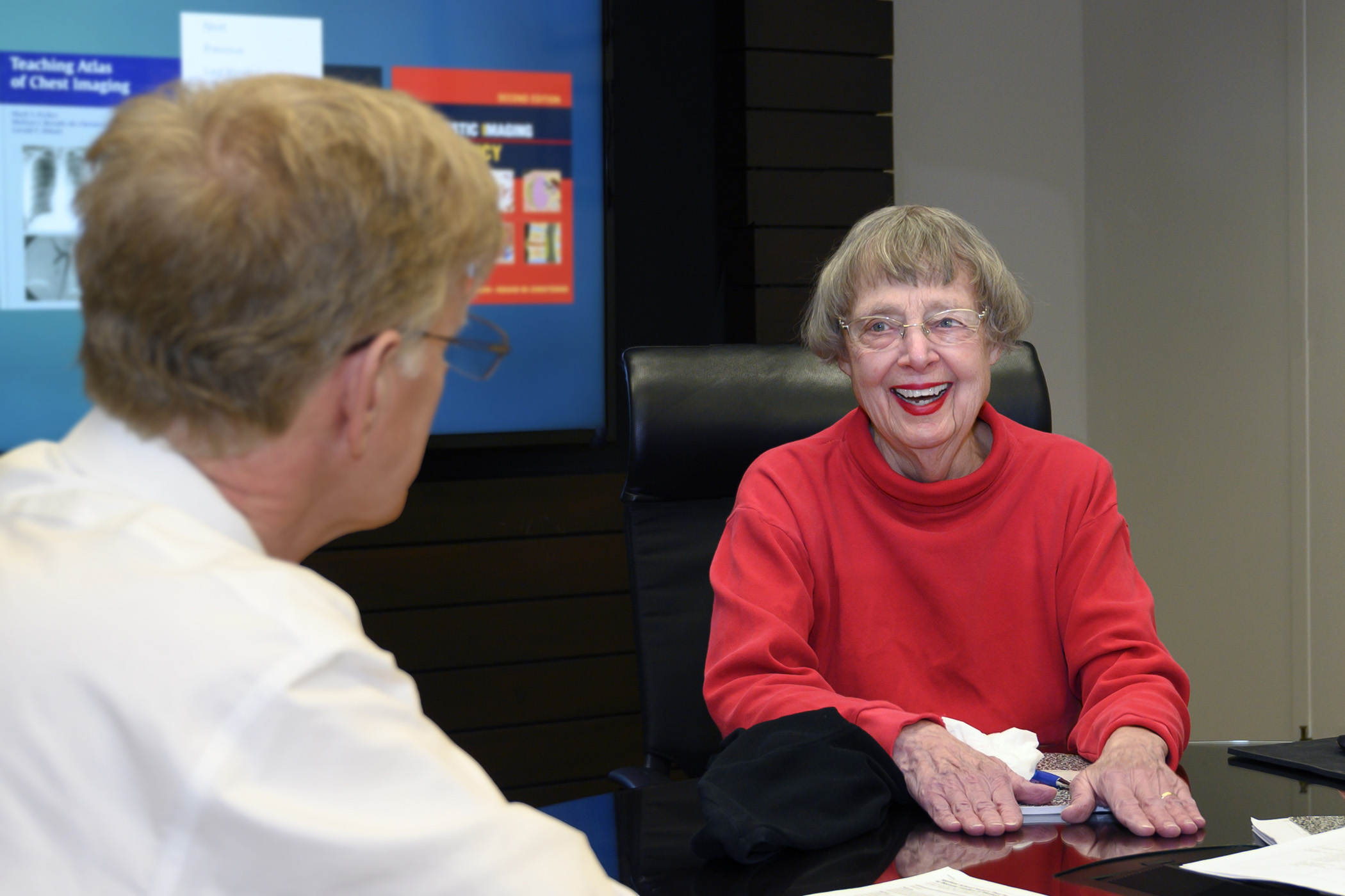 Louise Arnold, PhD, talking with a colleague at UMKC med school 