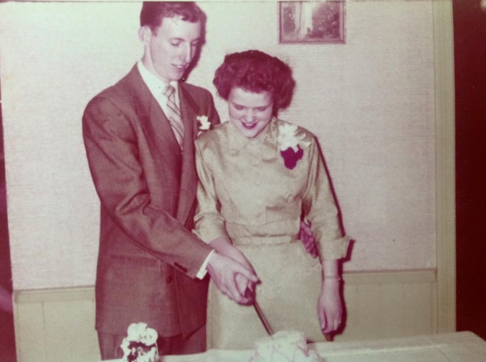 Jim and Rosie cutting cake at their wedding.