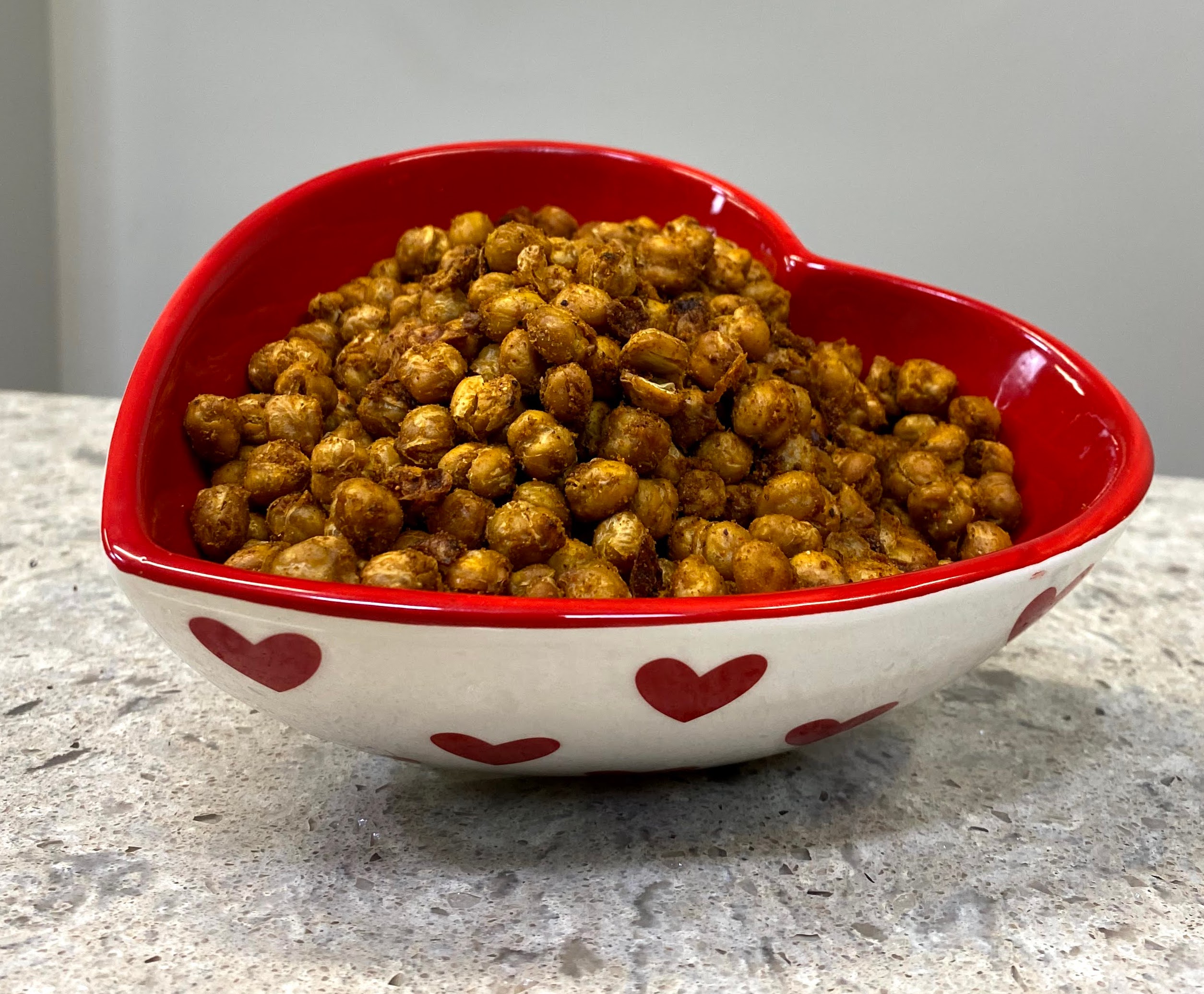 Spiced chickapeas in a heart shaped bowl. 