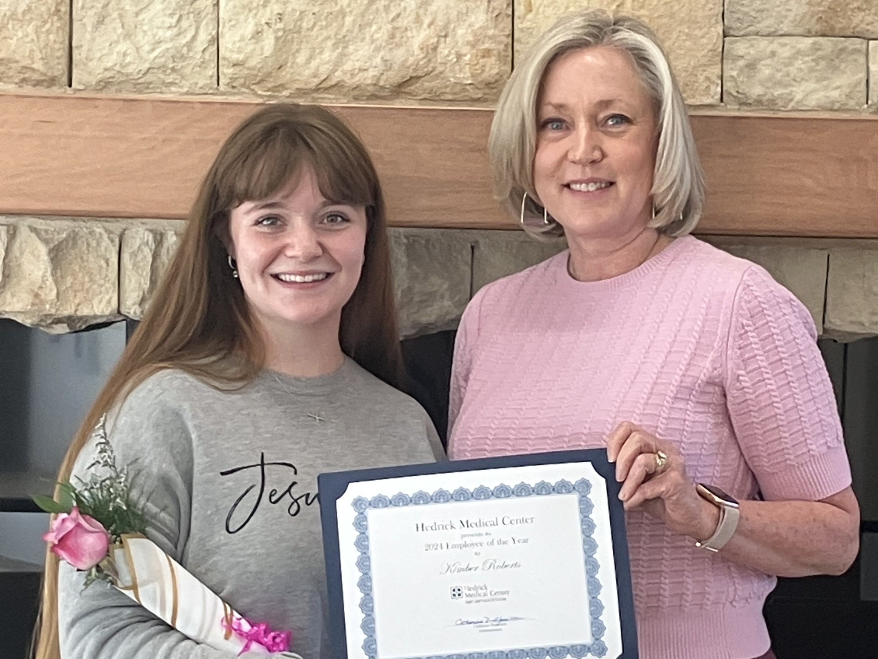Kimber Roberts (left) receives Hedrick Medical Center Employee of the Year Award for 2024 from Catherine Hamilton