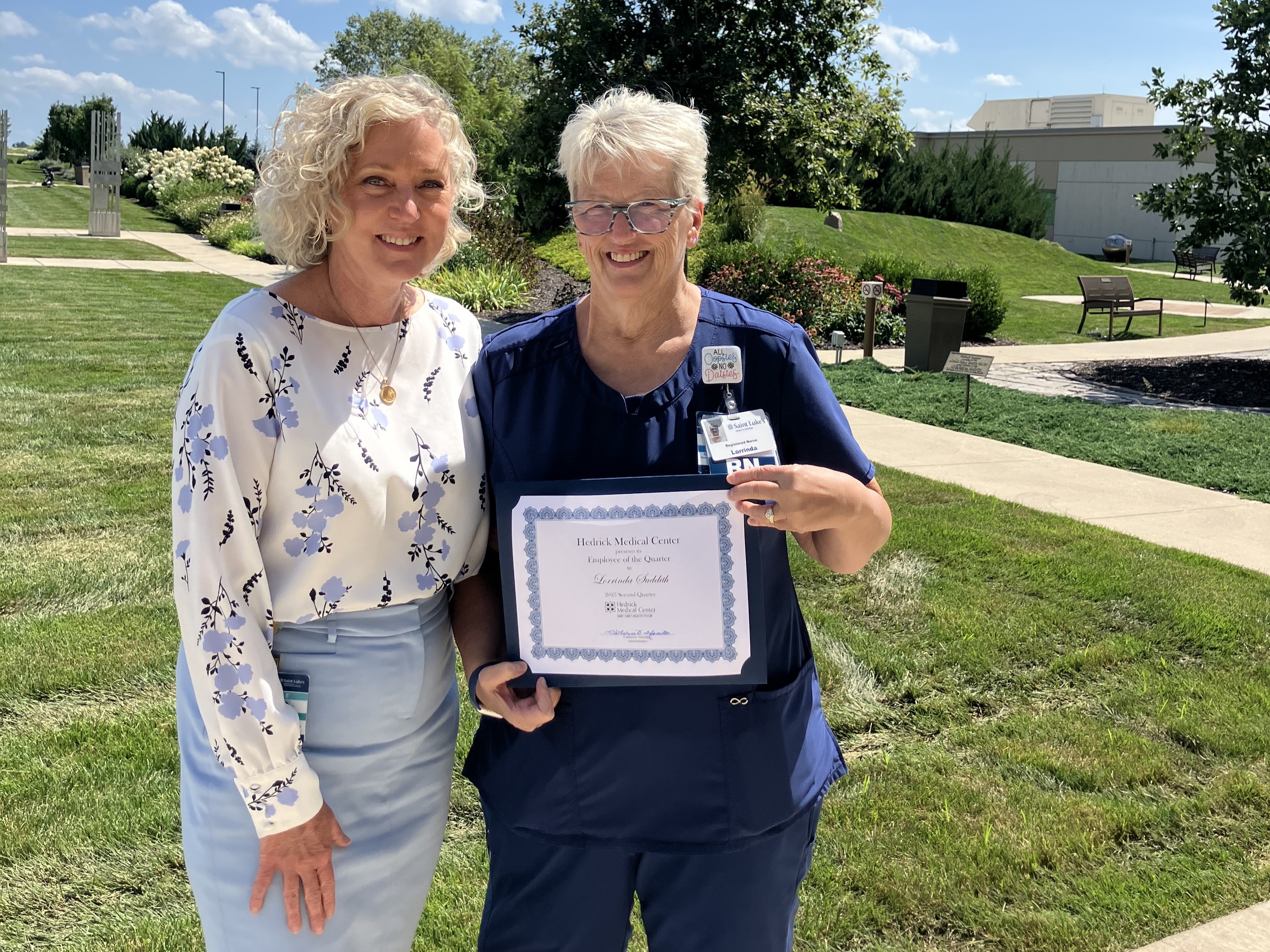 Lorrinda Suddith pictured with a colleague and her employee of the quarter certificate