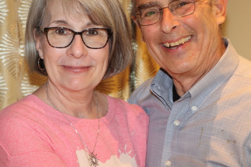 Mark, a Saint Luke's back pain patient, is smiling with his wife.
